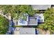 An aerial view of a modern home design with a metal roof and mature trees offering privacy at 1135 Florida Ave, Sarasota, FL 34236
