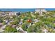 An aerial view showcases a home surrounded by lush greenery and a glimpse of the bay at 1135 Florida Ave, Sarasota, FL 34236