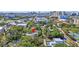 An aerial view shows the house surrounded by mature trees within a city setting at 1135 Florida Ave, Sarasota, FL 34236