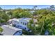 Aerial view of home with lush surroundings and a glimpse of the city skyline at 1135 Florida Ave, Sarasota, FL 34236