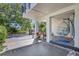 A covered back porch features a hanging chair, providing a relaxing outdoor space at 1135 Florida Ave, Sarasota, FL 34236