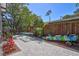 Spacious backyard featuring pavers, a table, tropical plants, bamboo fence, and kayak at 1135 Florida Ave, Sarasota, FL 34236