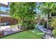 Secluded backyard featuring a wood deck, lush trees, well manicured yard, and beautiful landscape at 1135 Florida Ave, Sarasota, FL 34236