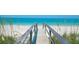 Beautiful beach access featuring a weathered boardwalk leading to white sands and clear turquoise waters at 1135 Florida Ave, Sarasota, FL 34236