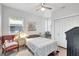 Cozy bedroom with ceiling fan, bedside table, and large window with blinds at 1135 Florida Ave, Sarasota, FL 34236