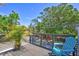 Inviting outdoor deck with lush greenery and a comfortable chair, perfect for relaxation at 1135 Florida Ave, Sarasota, FL 34236