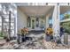 A charming front porch welcomes guests with decorative plants and a hanging chair at 1135 Florida Ave, Sarasota, FL 34236