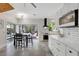 Bright kitchen with white cabinets, black accents, and sliding doors leading to a patio at 1135 Florida Ave, Sarasota, FL 34236