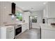 Bright white kitchen with stainless steel appliances and tiled backsplash at 1135 Florida Ave, Sarasota, FL 34236