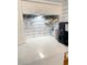Kitchen countertop featuring a coffee bar with quartz countertops and subway tile backsplash at 1135 Florida Ave, Sarasota, FL 34236