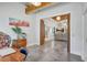 Open concept living room featuring wood beam ceilings and gray tiled floors at 1135 Florida Ave, Sarasota, FL 34236