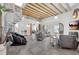 A spacious living room features a spiral staircase, exposed beam ceiling and modern furniture at 1135 Florida Ave, Sarasota, FL 34236