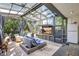 Relaxing sun room complete with tile floors, ceiling fan and comfortable furniture at 1135 Florida Ave, Sarasota, FL 34236