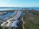 Stunning aerial view of waterfront townhomes surrounded by lush green landscaping and beautiful blue waters at 1218 Spoonbill Landings Cir, Bradenton, FL 34209