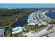 An aerial view features the property nestled along a serene waterway with lush landscaping and a community pool at 1218 Spoonbill Landings Cir, Bradenton, FL 34209