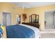 Relaxing bedroom boasts tile flooring, modern furniture, and bright paint color at 1218 Spoonbill Landings Cir, Bradenton, FL 34209