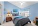 This cozy bedroom features stylish decor and a large window for ample light at 1218 Spoonbill Landings Cir, Bradenton, FL 34209