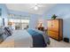 Light bedroom features tile flooring, side table, and large wardrobe cabinet at 1218 Spoonbill Landings Cir, Bradenton, FL 34209