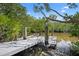 Private boat dock on a tranquil waterway, surrounded by lush mangrove vegetation at 1218 Spoonbill Landings Cir, Bradenton, FL 34209