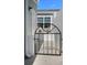 Private courtyard entrance with a decorative gate and a glimpse of outdoor seating, adding charm and security at 1218 Spoonbill Landings Cir, Bradenton, FL 34209