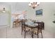 Charming dining area with open kitchen, chandelier, and decorative table setting at 1218 Spoonbill Landings Cir, Bradenton, FL 34209