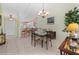 Bright dining area with access to an open kitchen, chandelier, and decorative table settings at 1218 Spoonbill Landings Cir, Bradenton, FL 34209
