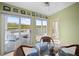 Bright dining area featuring sliding glass doors to a deck overlooking the water and a seating area at 1218 Spoonbill Landings Cir, Bradenton, FL 34209