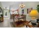 Bright dining room with decorative lighting fixture and a glass-top table set with seating for four at 1218 Spoonbill Landings Cir, Bradenton, FL 34209