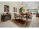Open-concept dining area featuring tile flooring, decorative bar cart, and seating for four at 1218 Spoonbill Landings Cir, Bradenton, FL 34209