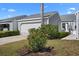 Charming exterior of home features a well-manicured lawn and a two-car garage at 1218 Spoonbill Landings Cir, Bradenton, FL 34209