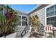 Inviting front entrance with tropical plants, stairs, and nice window trim for a touch of elegance at 1218 Spoonbill Landings Cir, Bradenton, FL 34209