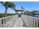 Picturesque gazebo overlooking the water, accessible by a charming boardwalk and lush greenery at 1218 Spoonbill Landings Cir, Bradenton, FL 34209