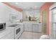 Well-lit kitchen featuring white appliances, ample counter space, and open layout to a seating area at 1218 Spoonbill Landings Cir, Bradenton, FL 34209