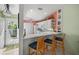 Bright kitchen with white cabinetry, breakfast bar, and adjacent entry door and exterior view at 1218 Spoonbill Landings Cir, Bradenton, FL 34209