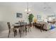 Spacious living room with dining area, chandelier, high ceiling, and an abundance of natural light at 1218 Spoonbill Landings Cir, Bradenton, FL 34209
