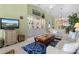Cozy living room with bright interior, comfortable furnishings, and an open view of the dining area at 1218 Spoonbill Landings Cir, Bradenton, FL 34209