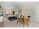 Open living room with a dining area, ceiling fans, comfortable furnishings, and tile flooring throughout at 1218 Spoonbill Landings Cir, Bradenton, FL 34209