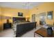 The main bedroom features a large bed, yellow walls, an ensuite bathroom, and ample natural light at 1218 Spoonbill Landings Cir, Bradenton, FL 34209