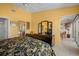 Bright main bedroom with ensuite bathroom, vanity, tile floors, and lanai access offering serene waterfront view at 1218 Spoonbill Landings Cir, Bradenton, FL 34209