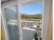 View from sliding door to patio featuring seating, table, and peaceful waterfront views at 1218 Spoonbill Landings Cir, Bradenton, FL 34209