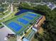 Aerial view of well-maintained tennis courts and recreational facilities within the community at 1218 Spoonbill Landings Cir, Bradenton, FL 34209
