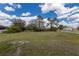 Spacious backyard with mature trees and green grass at 1269 Rasp Ct, North Port, FL 34288