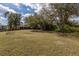 Spacious backyard with mature trees and a well-maintained lawn at 1269 Rasp Ct, North Port, FL 34288