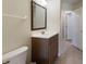 Cozy bathroom with wood-look vanity, tile floor and neutral colored walls at 1269 Rasp Ct, North Port, FL 34288