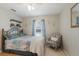 Charming bedroom with a wrought iron bed frame and an accent chair at 1269 Rasp Ct, North Port, FL 34288
