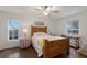 Bright bedroom with wood floors, windows, and ceiling fan at 1269 Rasp Ct, North Port, FL 34288