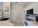 Well-lit kitchen features white cabinetry and appliances at 1269 Rasp Ct, North Port, FL 34288