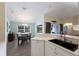 Open kitchen with modern sink, countertops, and view to dining area at 1269 Rasp Ct, North Port, FL 34288