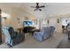 Living room with lots of comfortable seating, tv and ceiling fan at 1269 Rasp Ct, North Port, FL 34288