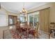 Elegant dining room with chandelier, seating for six, sliding glass door, and stunning water views at 1364 Point Crisp Rd, Sarasota, FL 34242
